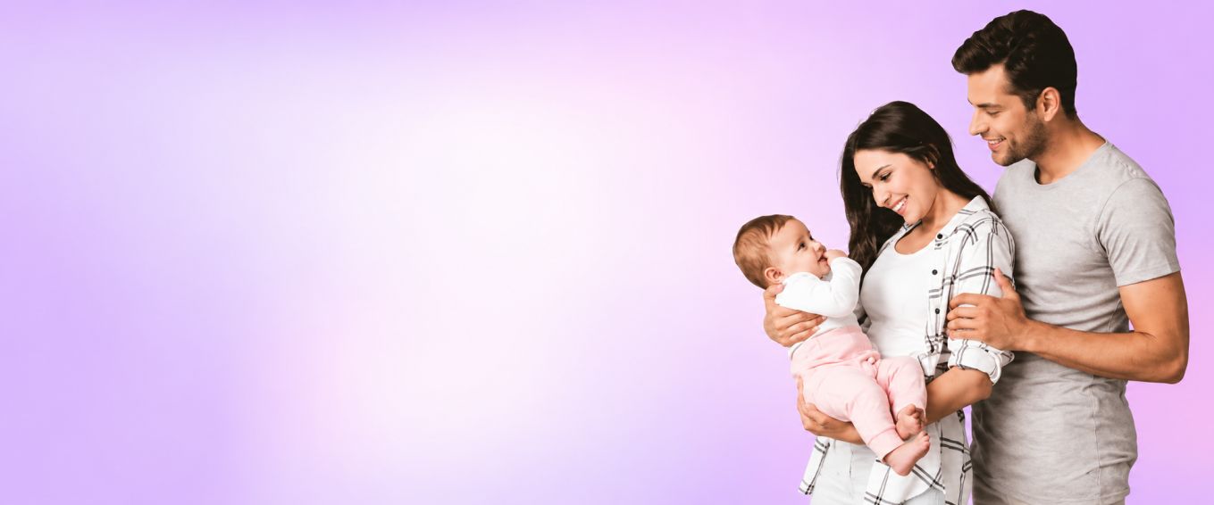 Happy family with parents holding their baby together
